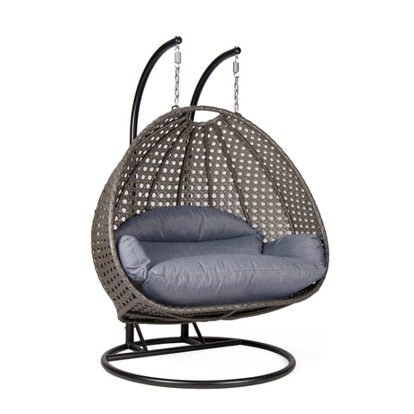 Hangstoel Dubai bruin met zwart frame en dusty blue kussen 